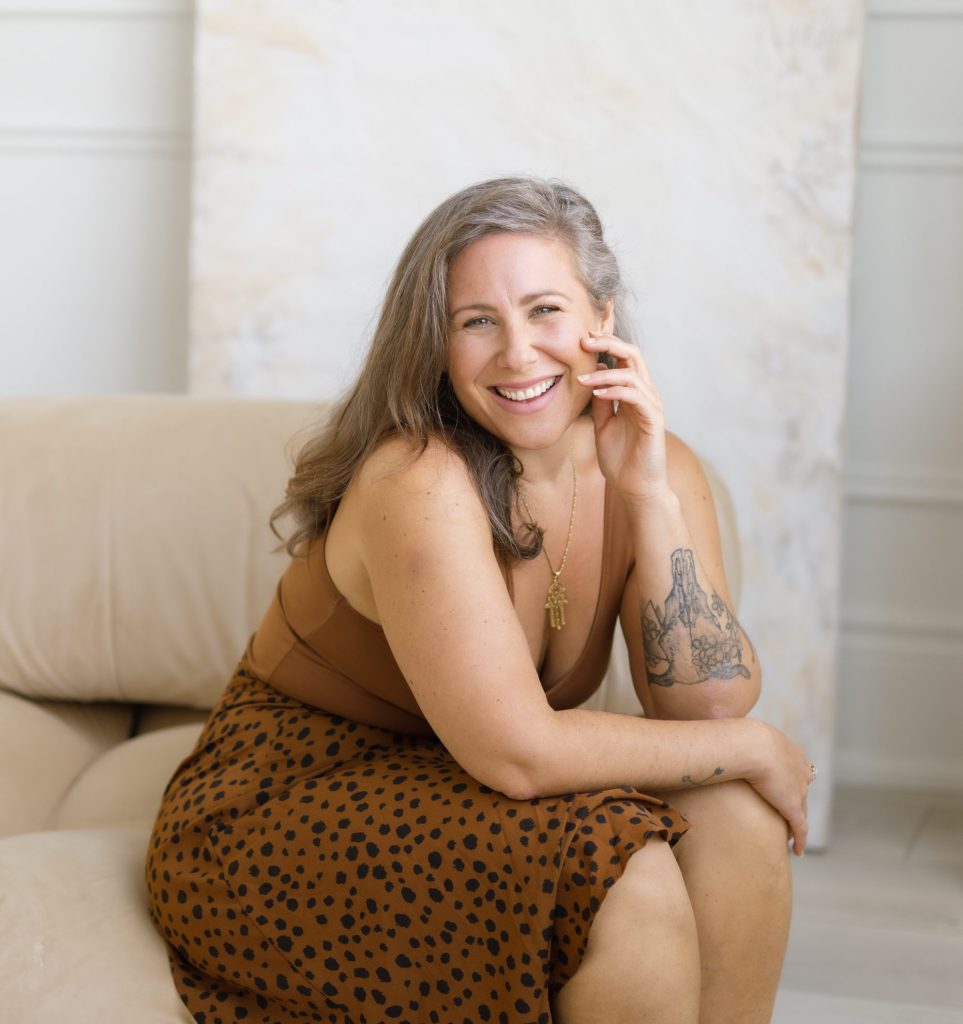 Portrait of Jaime Verk, somatic energy healer & relationship, intimacy coach, seated calmly in a warm neutral setting.