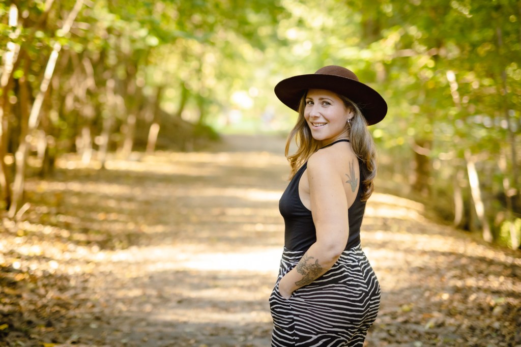 Jaime Verk walking down a tree lined path. 