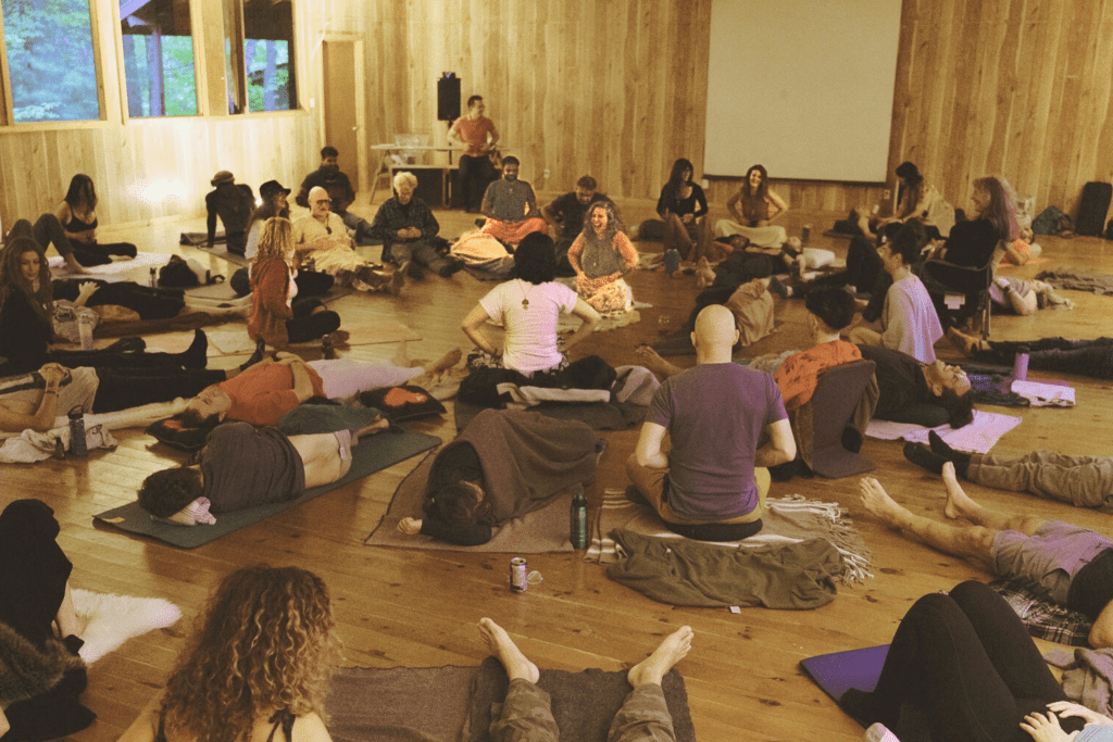 Jaime Verk facilitating a large group through a somatic process. 